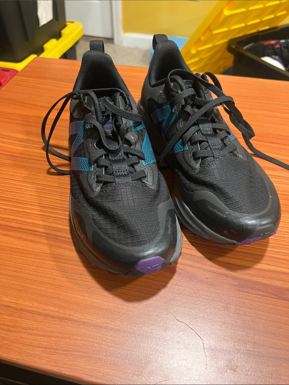 New Balance Men's Black Athletic Shoes with Teal and Purple Accents
